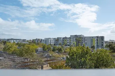 a view of an apartment complex with trees and buildings at Chic 1 bedroom apt in Century city in Cape Town