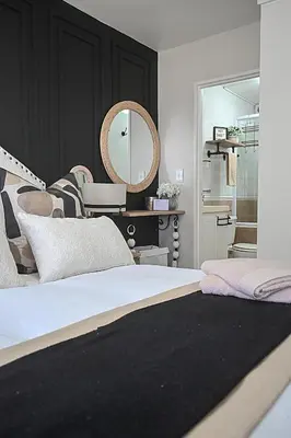a bedroom with a bed with a mirror on the wall at SeeHUYS Boutique Bloubergstrand Beachfront Studio in Bloubergstrand
