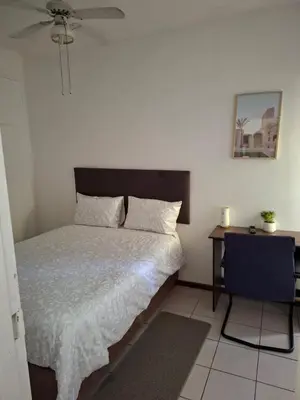 a bedroom with a bed and a nightstand with a bed sidx sidx sidx sidx at Chez Yves in Hoheizen