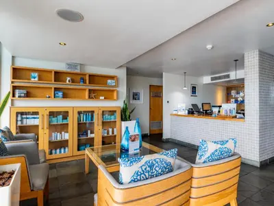 a living room with a couch and a table at Lagoon Shoreline 2 Bedroom Apartment in Cape Town