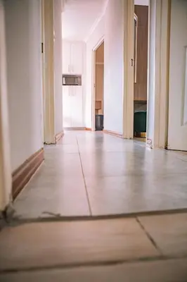 an empty room with white walls and a wooden floor at 26 on Balfour Crescent in Silver Sands