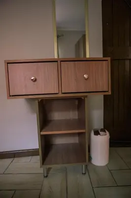 a wooden cabinet with two doors and a mirror at 26 on Balfour Crescent in Silver Sands