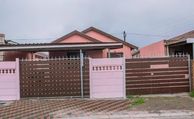 a fence with pink doors in front of a house at 26 on Balfour Crescent in Silver Sands