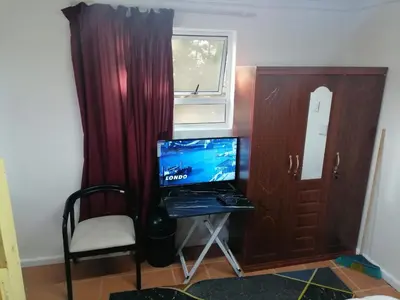 a room with a desk with a computer and a window at 72 the trout lodge in Goodwood