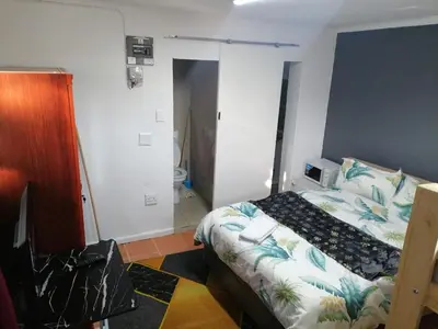 a small bedroom with a bed and a bathroom at 72 the trout lodge in Goodwood