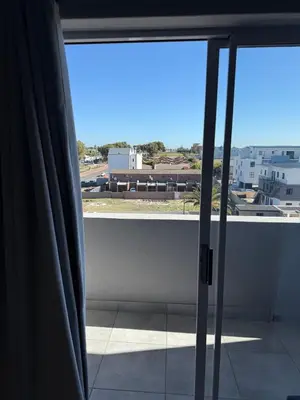 an open window with a view of a city at Table Mountain View Apartment in Cape Town