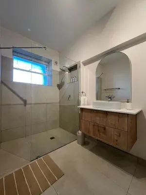a bathroom with a sink and a shower with a mirror at Bosch & Bloom in Stellenbosch