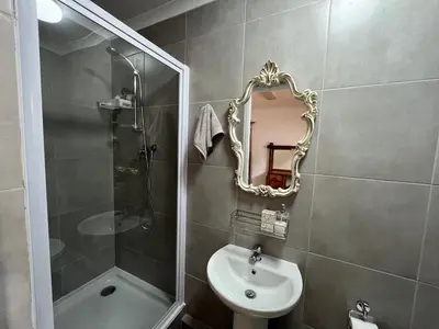 a bathroom with a mirror and a sink and a shower at Central Somerset Stay in Somerset West