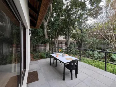 a table and chairs sitting on a patio at Central Somerset Stay in Somerset West