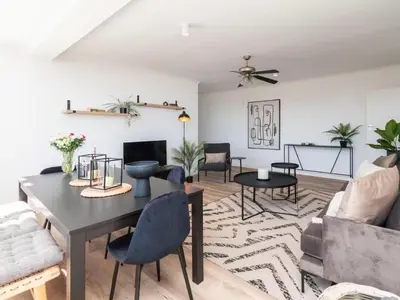 a living room with a table and chairs at Atticus Self Catering Accommodation in Cape Town