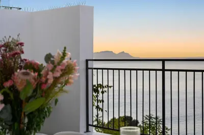 a balcony with a view of the ocean at Suikerbossie 52 in Cape Town