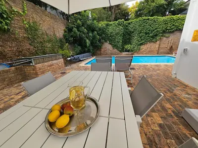 a plate of fruit on a table on a patio at 5 Rembrandt Guesthouse in Somerset West