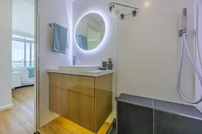 a bathroom with a sink and a mirror at Luxury Beachfront-LaVista with Mountain & Ocean views in Bloubergstrand