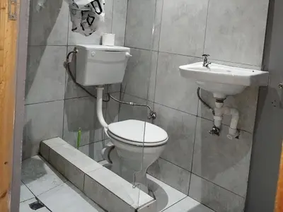 a bathroom with a toilet and a sink at Eneco Lodge in Cape Town