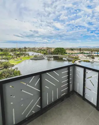 a balcony with a view of a body of water at Olive Apartment on Bridgewaters in Cape Town