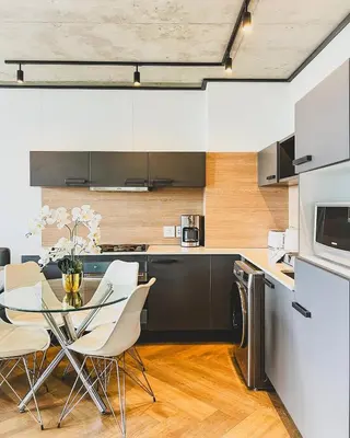 a kitchen with a table and chairs in a room at Olive Apartment on Bridgewaters in Cape Town