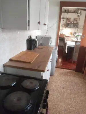 a kitchen with a stove with a wooden counter top at Halibut Suite in Strand