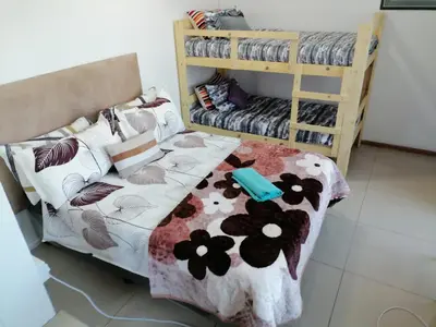 a bedroom with a bed and bunk beds at 72 Hamilton the trout lodge in Goodwood