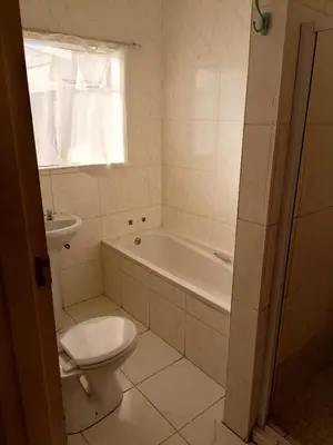 a bathroom with a toilet and a tub and a sink at 72 Hamilton the trout lodge in Goodwood