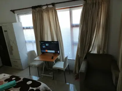 a room with a desk with a computer on it at 72 Hamilton the trout lodge in Goodwood