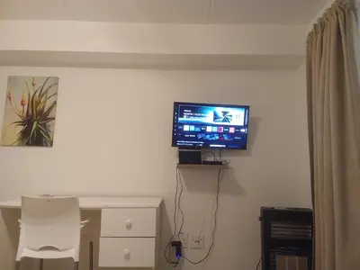 a flat screen tv on a wall in a room at Klipkop Self-catering Haven in Cravenby