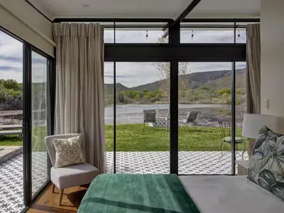 a bedroom with a bed and a large glass window at Lily Pond in Worcester