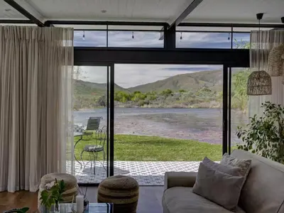 a living room with a view of a river at Lily Pond in Worcester