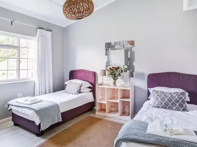 a bedroom with two beds and a window at Vineyard House in Worcester