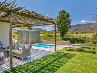 a backyard with a pergola and a swimming pool at Vineyard House in Worcester