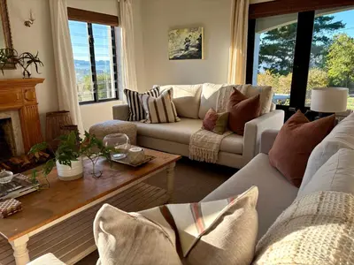 a living room with two couches and a coffee table at Libertas House, Cheverells Farm in Grabouw