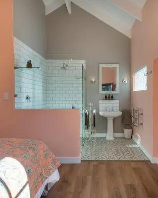a bedroom with a bed and a bathroom with a sink at Crabapple Cottage, Cheverells Farm in Ouda Brug