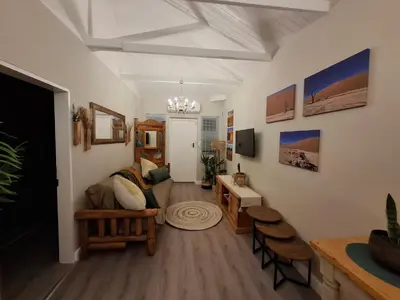 a living room with a couch and a table at Mukuru Okunene in Strand