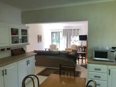 a kitchen and living room with a couch and a table at River Front in Stellenbosch