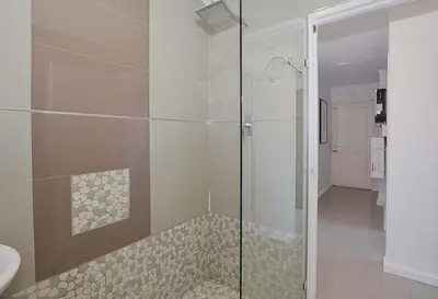 a bathroom with a shower with a glass door at Ocean View B401 by CTHA in Bloubergstrand