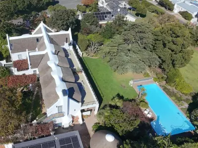 an aerial view of a house with a swimming pool at The Bothey House in Somerset West