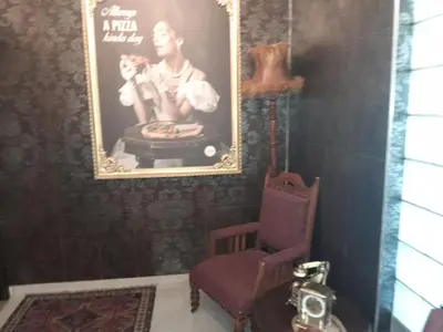 a room with a picture of a man and a chair at Sunset 786 Holiday Accommodation-Room 208 in Strand