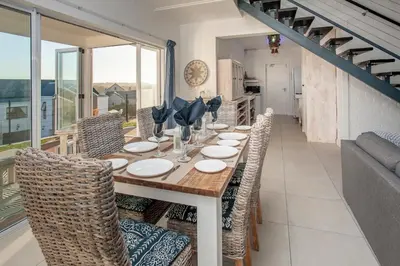 a dining room with a long table and chairs at Vermont Vista - With Pool in Hermanus