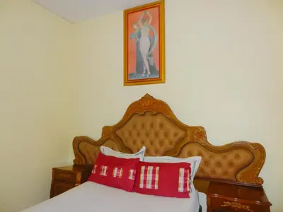 a bedroom with a bed with red and white pillows at Ngena Sleep and Go Goodwood in Goodwood