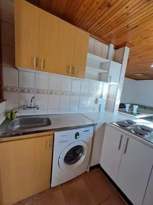 a kitchen with a washing machine and a sink at Azzure Apartments 4 sleeper Crawford in Cape Town