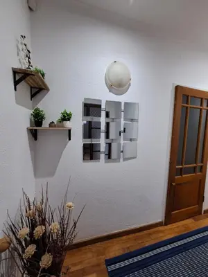 a room with a white wall with some plants on it at Azzure Apartments 6 sleeper Crawford in Cape Town