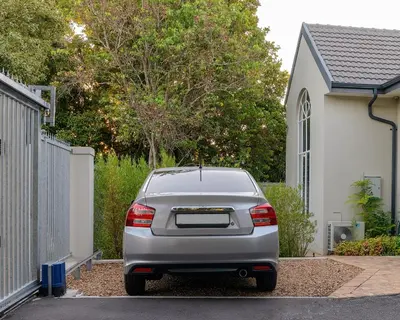 a silver car parked in front of a house at Arch Window garden apartment in Stellenbosch