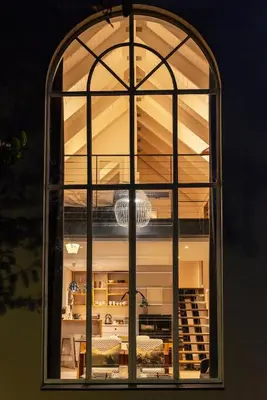 a large window in a room with a table at Arch Window garden apartment in Stellenbosch