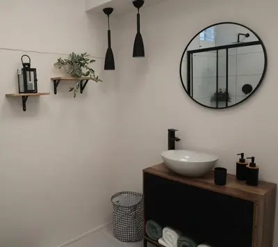 a bathroom with a sink and a mirror on the wall at 64 On Forest in Cape Town
