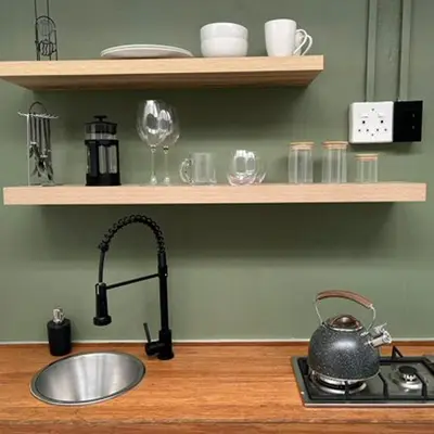 a kitchen sink with a tea kettle on a stove at 64 On Forest in Cape Town