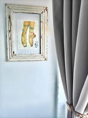 a picture of a pair of shoes on a wall next to a window at Sand Sittie in Sandbaai