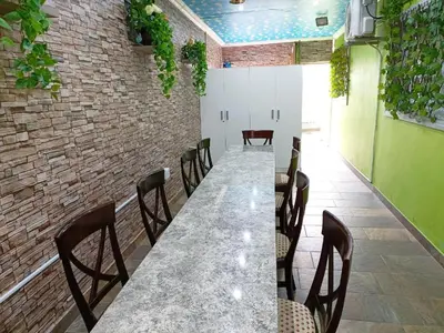 a dining room with a long table and chairs at Camdene Guesthouse in Cape Town