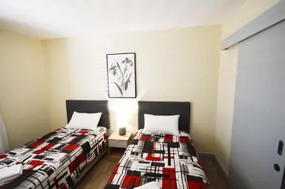 two beds in a small room with sidx sidx sidx sidx at 402 Ocean View in Strand