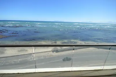 a view of a road and the ocean from an airplane at 402 Ocean View in Strand