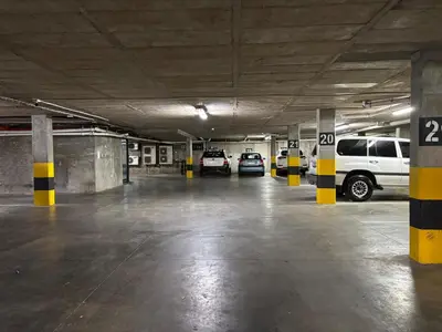 a parking garage with several cars parked in it at Modern living in central town in Stellenbosch