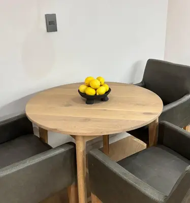 a bowl of fruit sitting on a wooden table at Modern living in central town in Stellenbosch